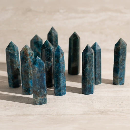 Blue crystal points arranged on a sandy surface