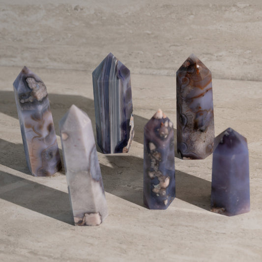 Set of six crystal points on a beige surface