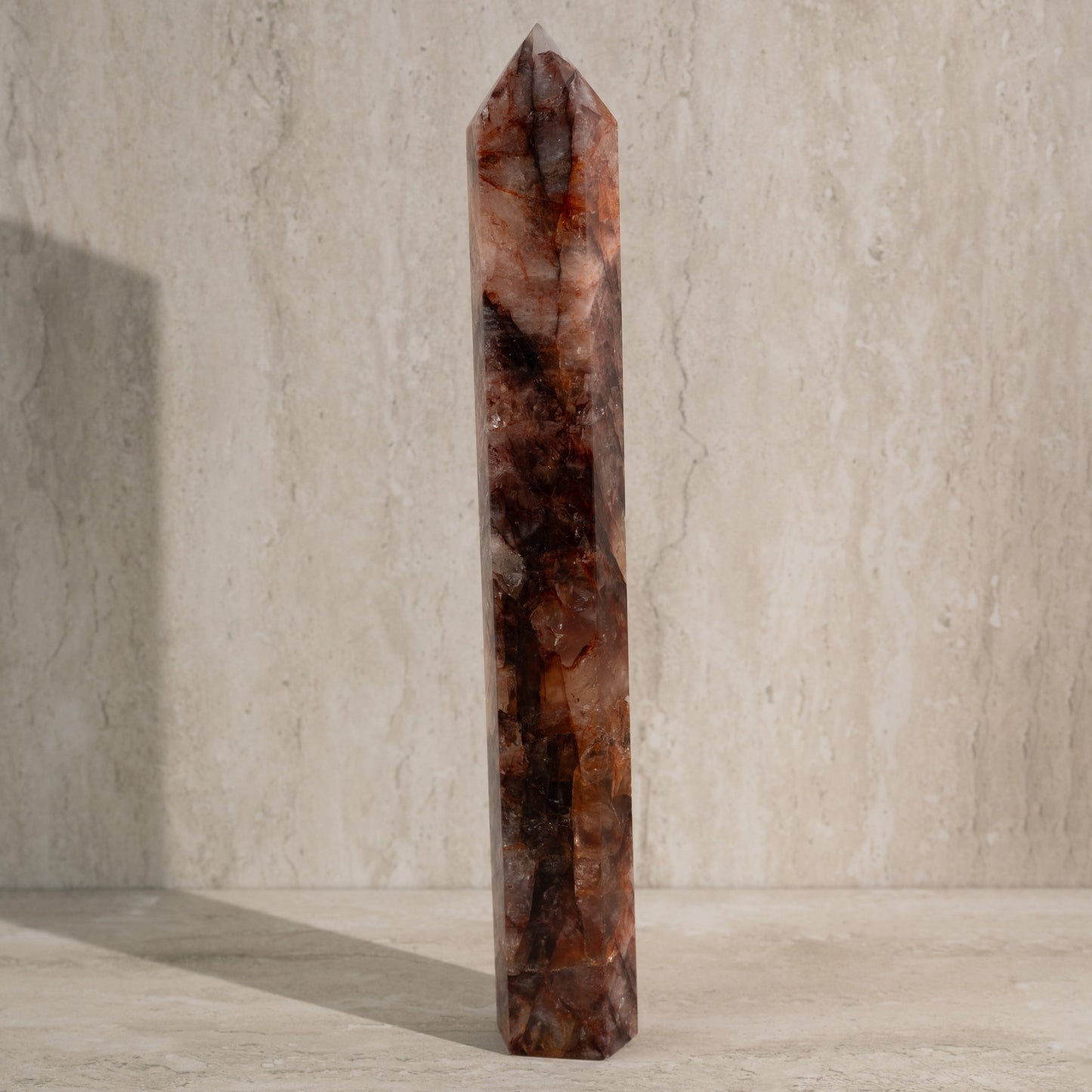 Tall, brown crystal tower on a neutral background