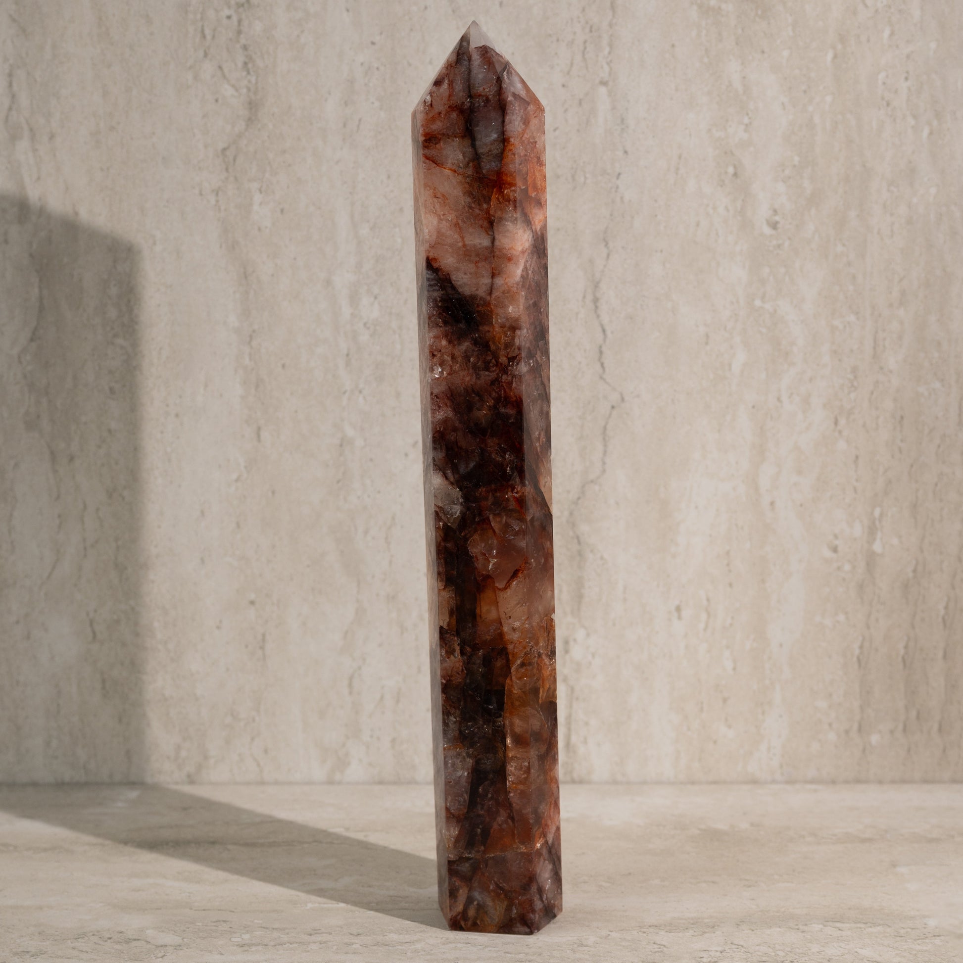 Tall, brown crystal tower on a neutral background