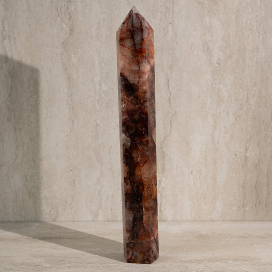 Tall, brown crystal tower on a neutral background