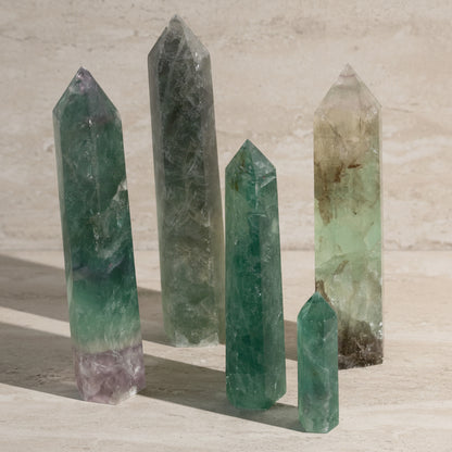 Set of green crystal points on a stone surface