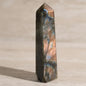 Polished labradorite crystal on a neutral background