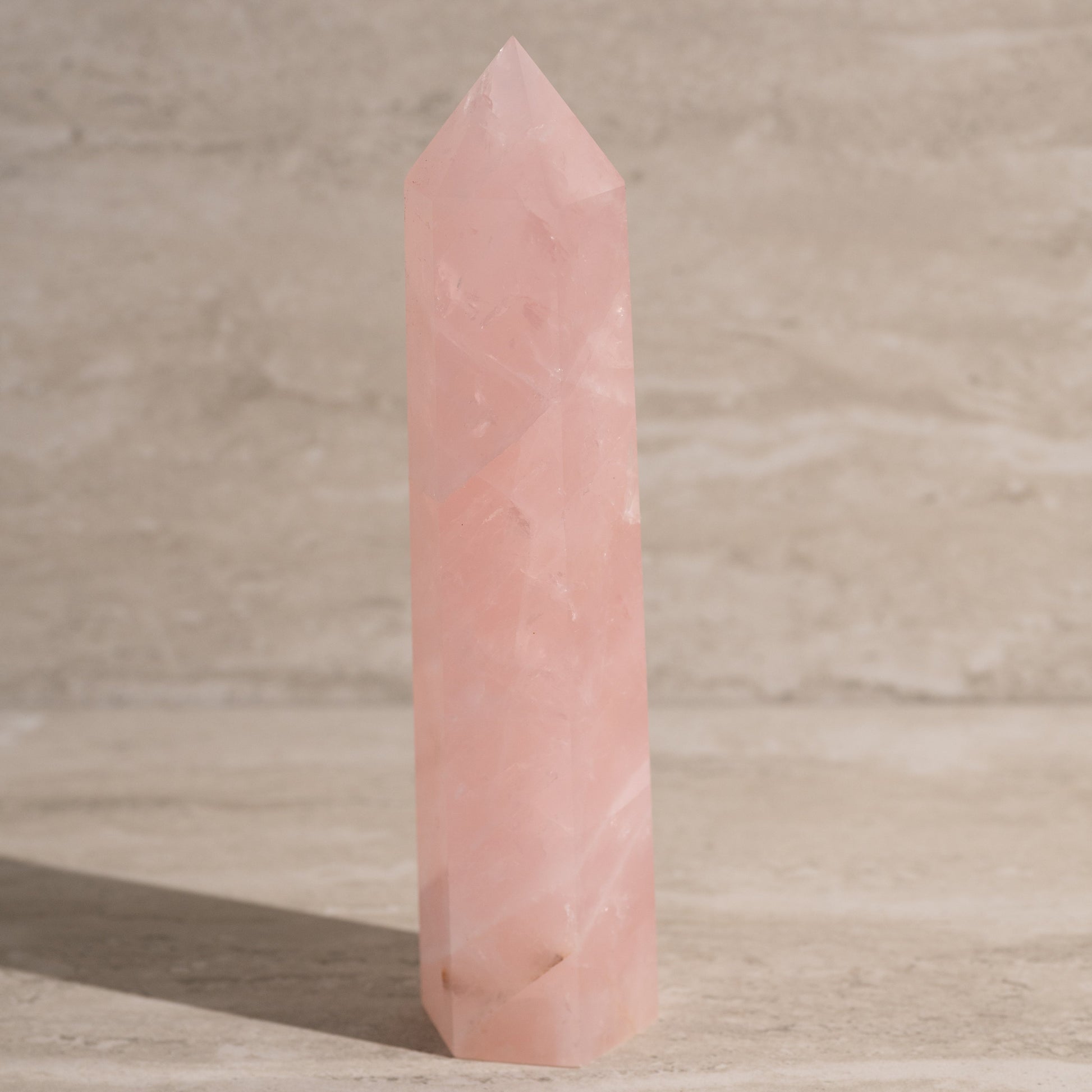 Pink crystal tower on a wooden surface