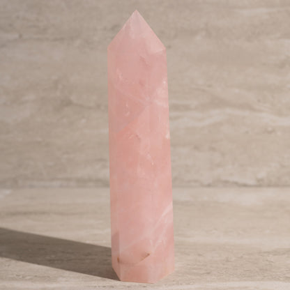 Pink crystal tower on a wooden surface