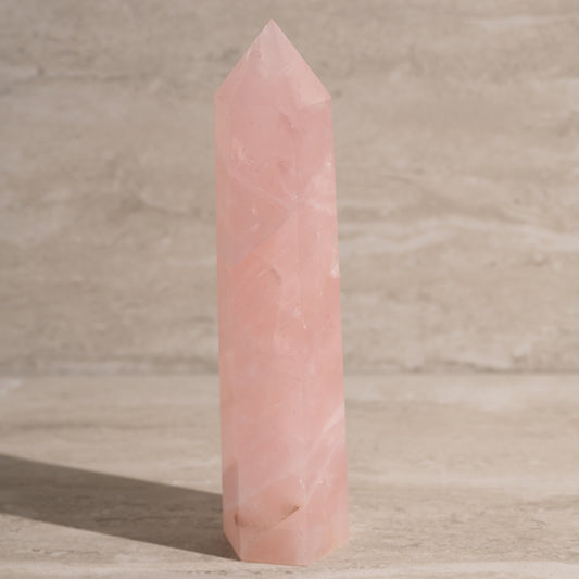Pink crystal tower on a wooden surface