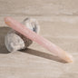 Pink crystal on a stone with a neutral background